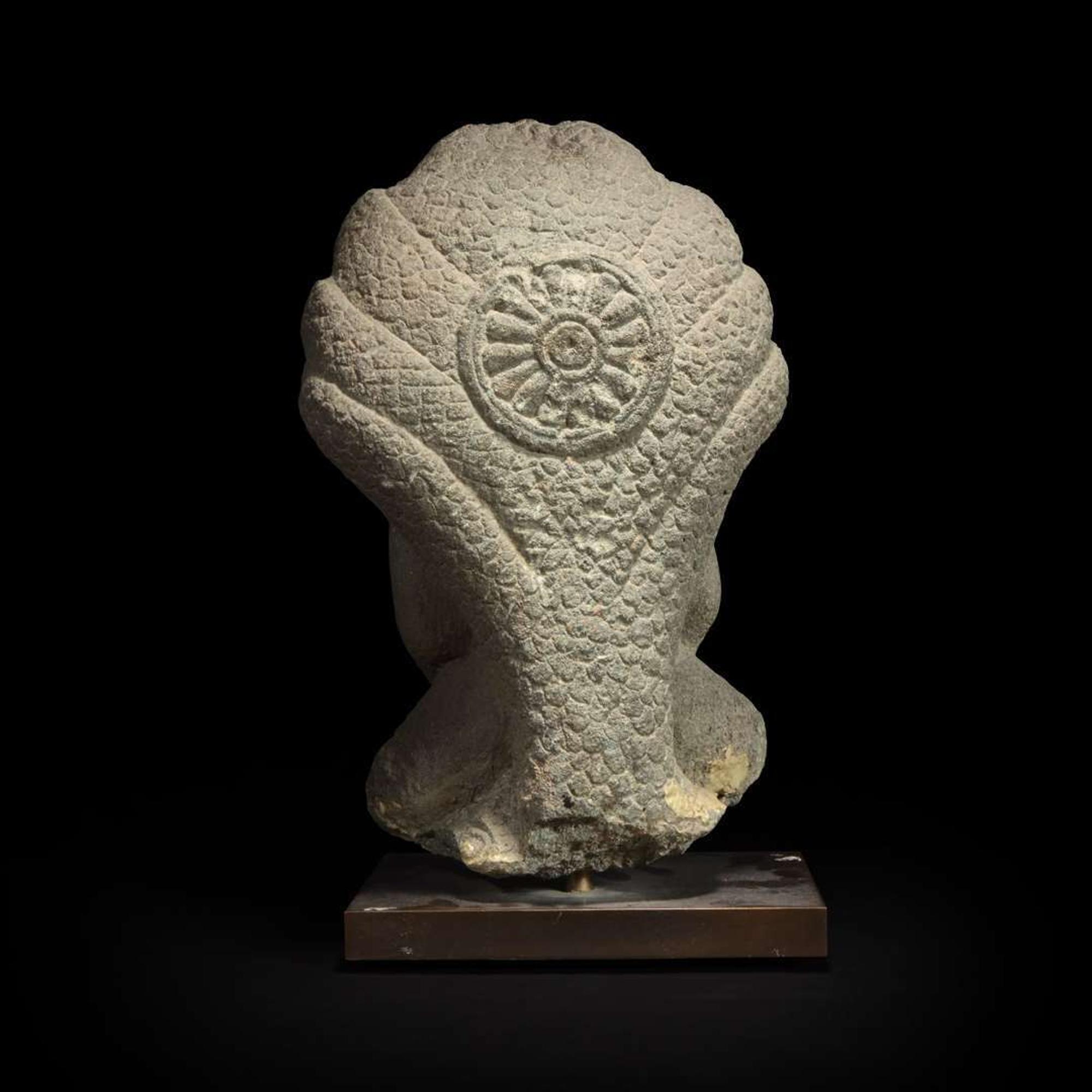 A Khmer style carved stone figure of Buddha seated under a cobra canopy 高棉风格石雕眼镜蛇冠冕佛首
