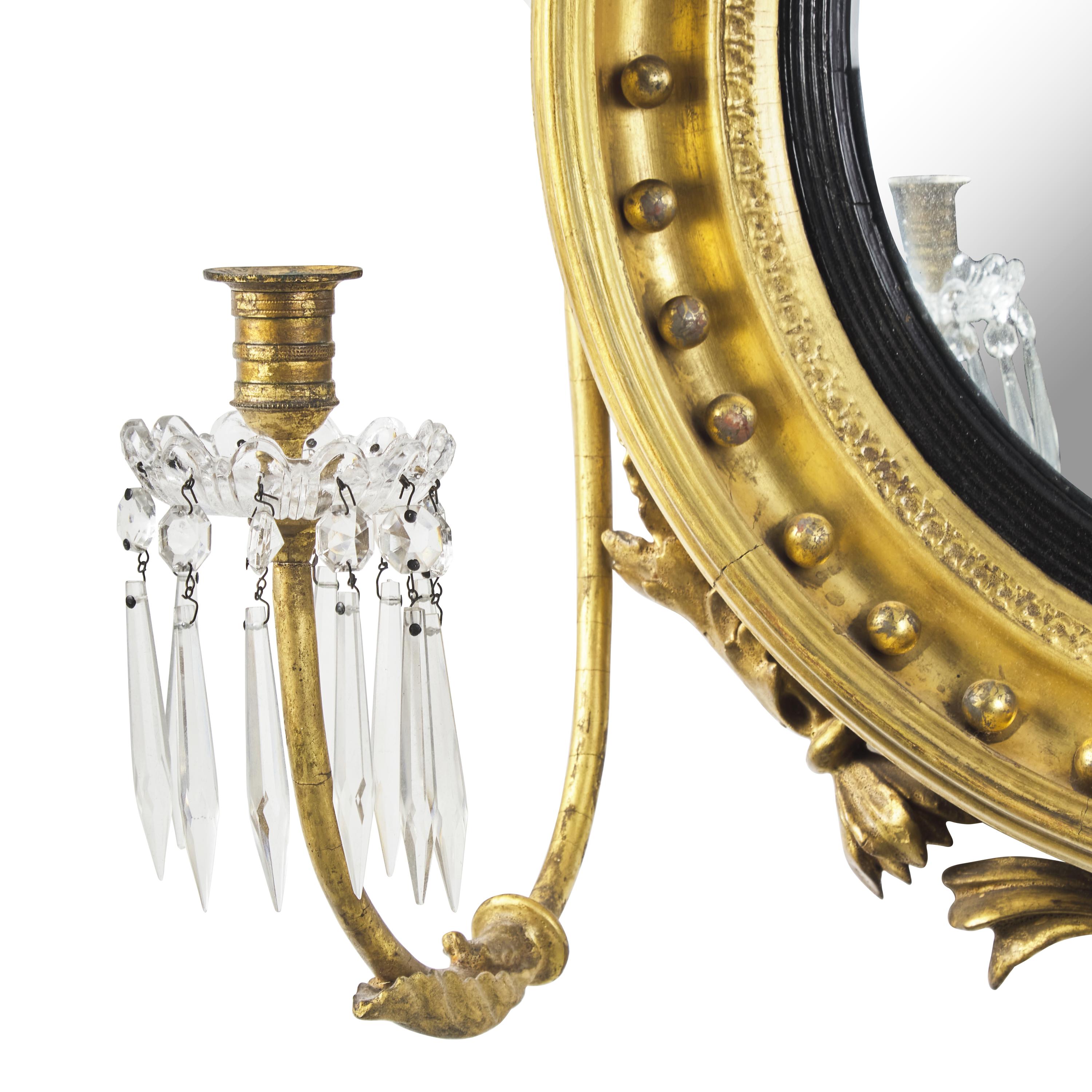 A Classical Carved, Gilt and Parcel Ebonized Two-Light Bull's Eye Girandole Mirror