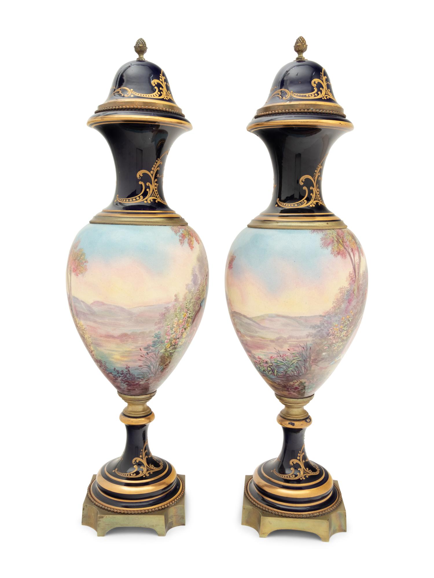 A Pair of Sèvres Style Gilt Bronze Mounted Porcelain Urns