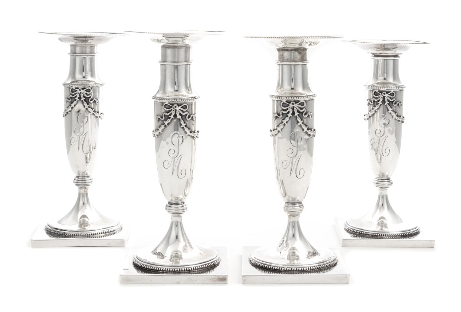 A Set of Four American Silver Candlesticks, Whiting Mfg. Co., New York, NY, each baluster stem with applied bellflower garlands.