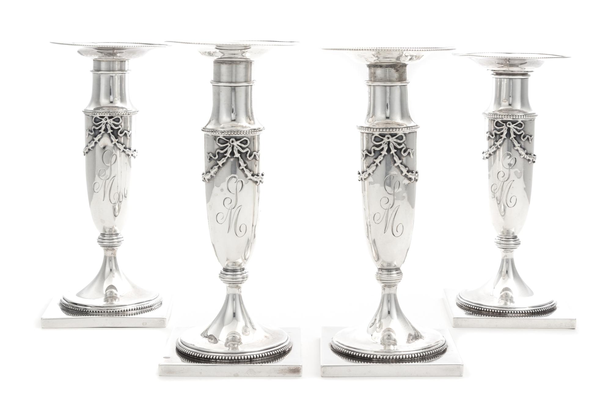 A Set of Four American Silver Candlesticks, Whiting Mfg. Co., New York, NY, each baluster stem with applied bellflower garlands.