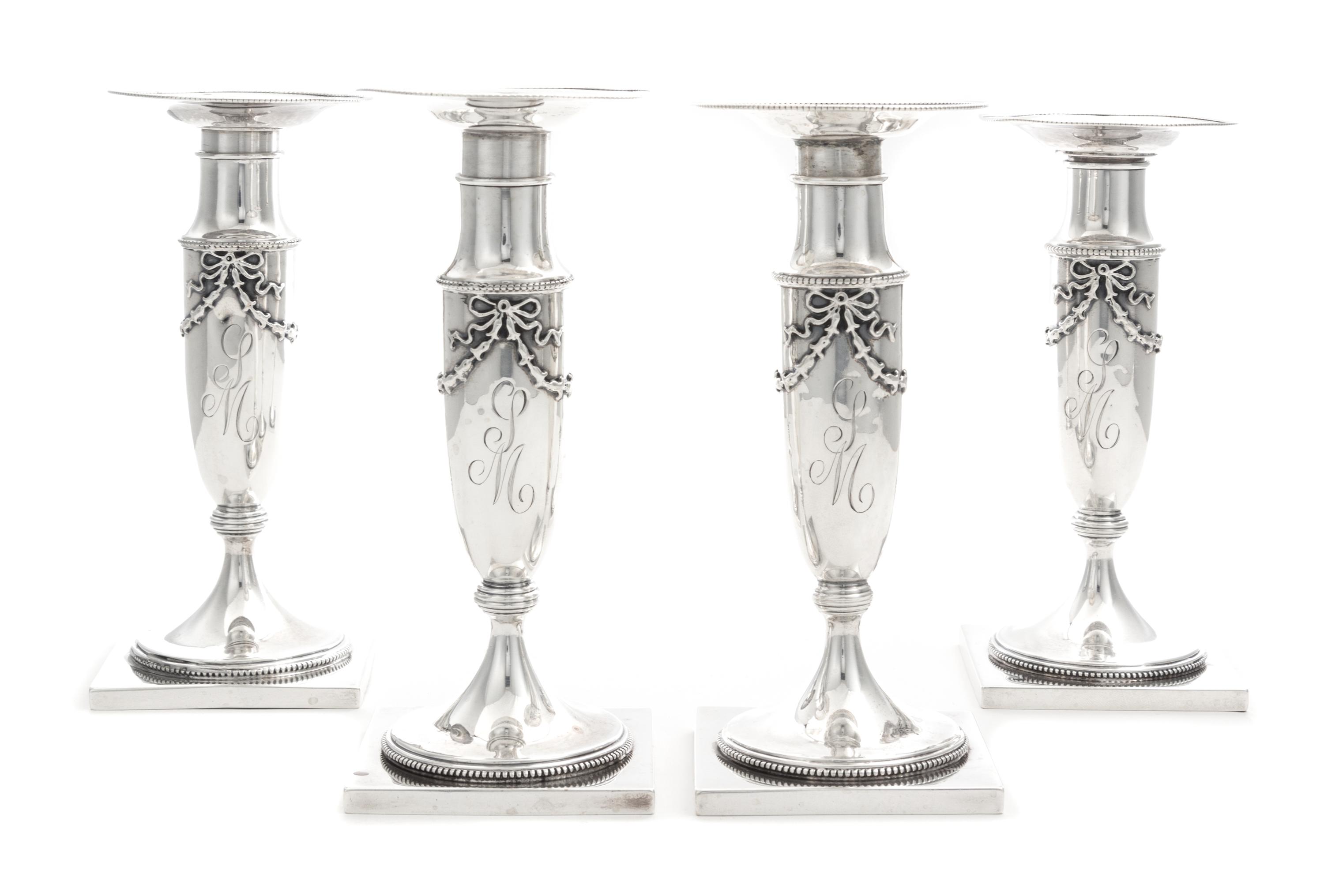 A Set of Four American Silver Candlesticks, Whiting Mfg. Co., New York, NY, each baluster stem with applied bellflower garlands.
