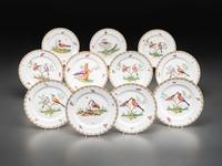 An English Parcel Gilt Bird and Insect Decorated Porcelain Partial Dinner Service