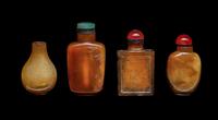 Four Chinese Carved Russet Jade and Hardstone Snuff Bottles