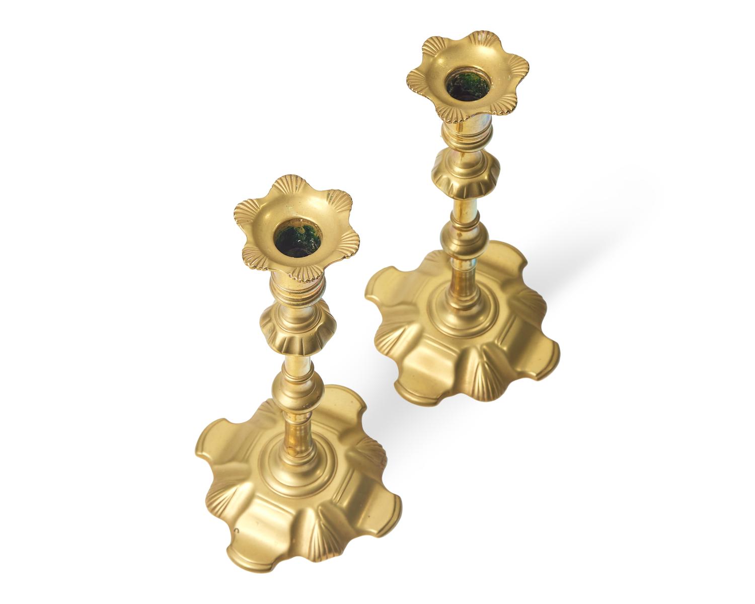 A Group of Four George III Brass Candlesticks