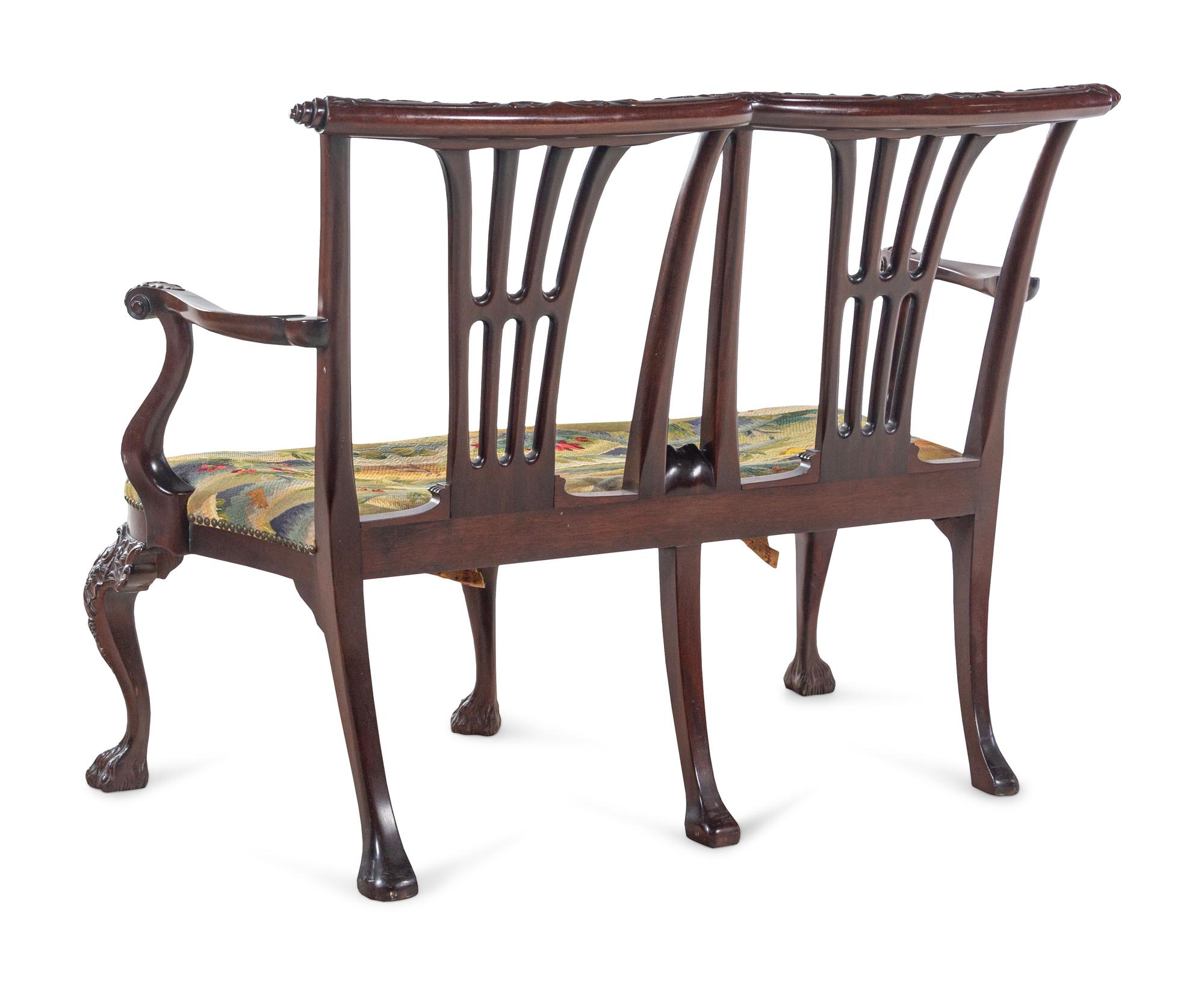 A Pair of Irish George II Style Carved Mahogany Double-Back Settees