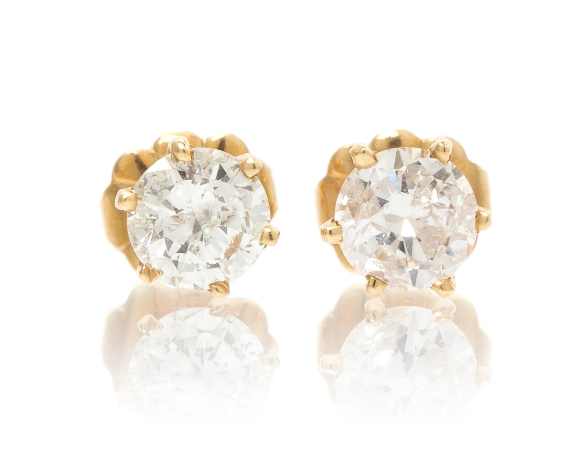 A Pair of 14 Karat Yellow Gold and Diamond Stud Earrings, 0.70 dwts.