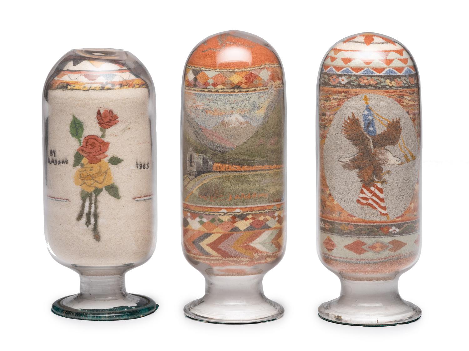 A Collection of John A. Adams Sand Art Bottles, Along with Custom Box and Unused Bottle
