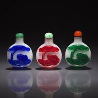 Three Chinese Overlay Glass "Xuanwu" Snuff Bottles, Qing Dynasty, 18th/19th Century — 清中晚期 雪霏地套料鼻煙壺三支