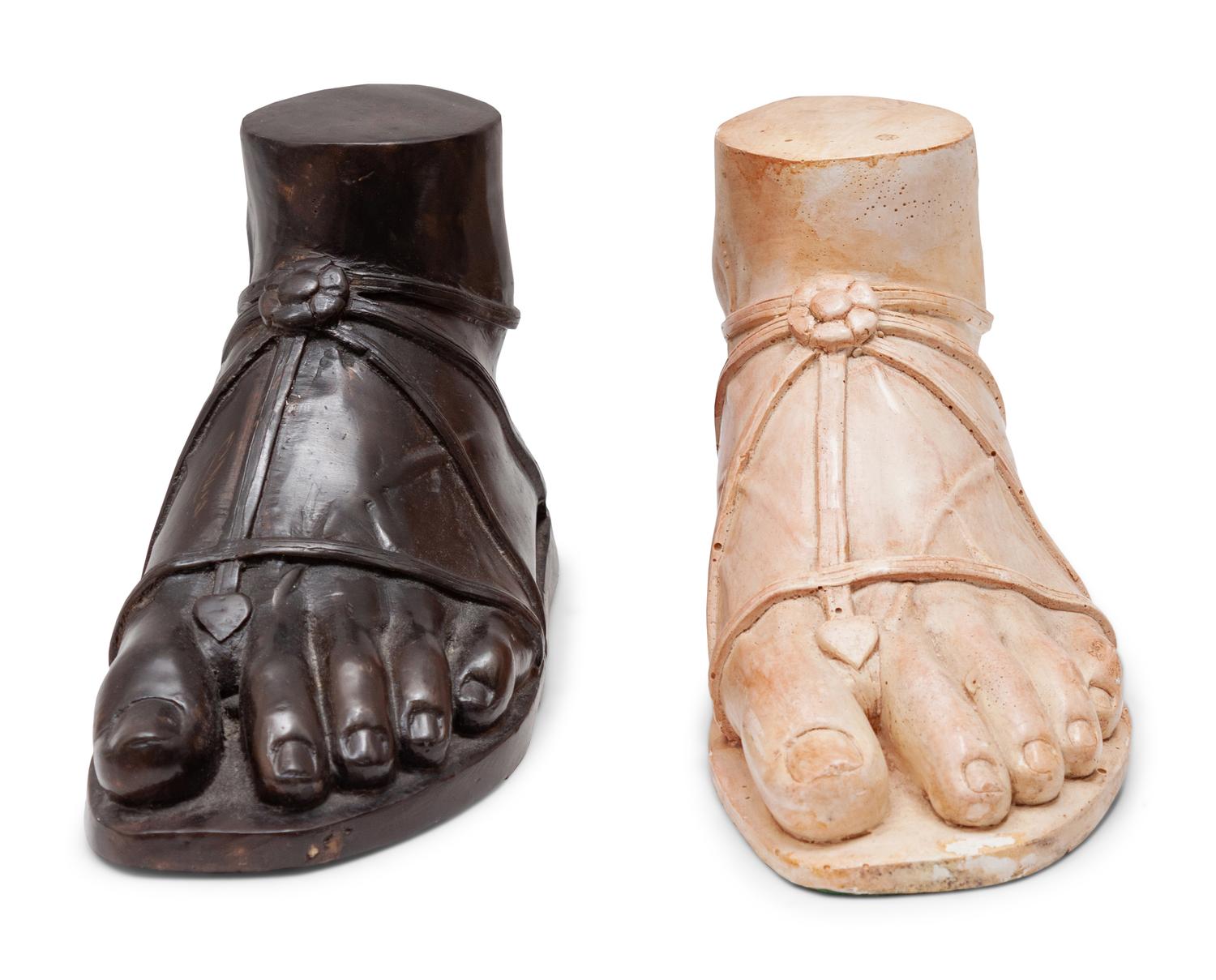 A Pair of Composition and Bronze Paw and Foot Form Doorstops
