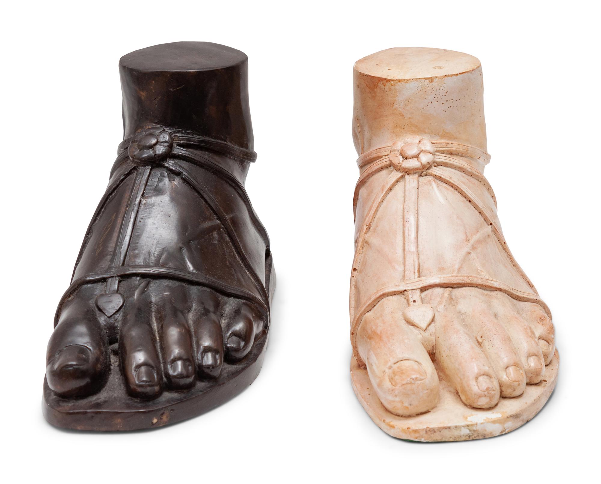 A Pair of Composition and Bronze Paw and Foot Form Doorstops