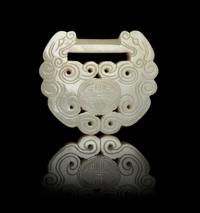 A Carved Pale Celadon Jade Lock-Form Pendant — 19TH CENTURY
