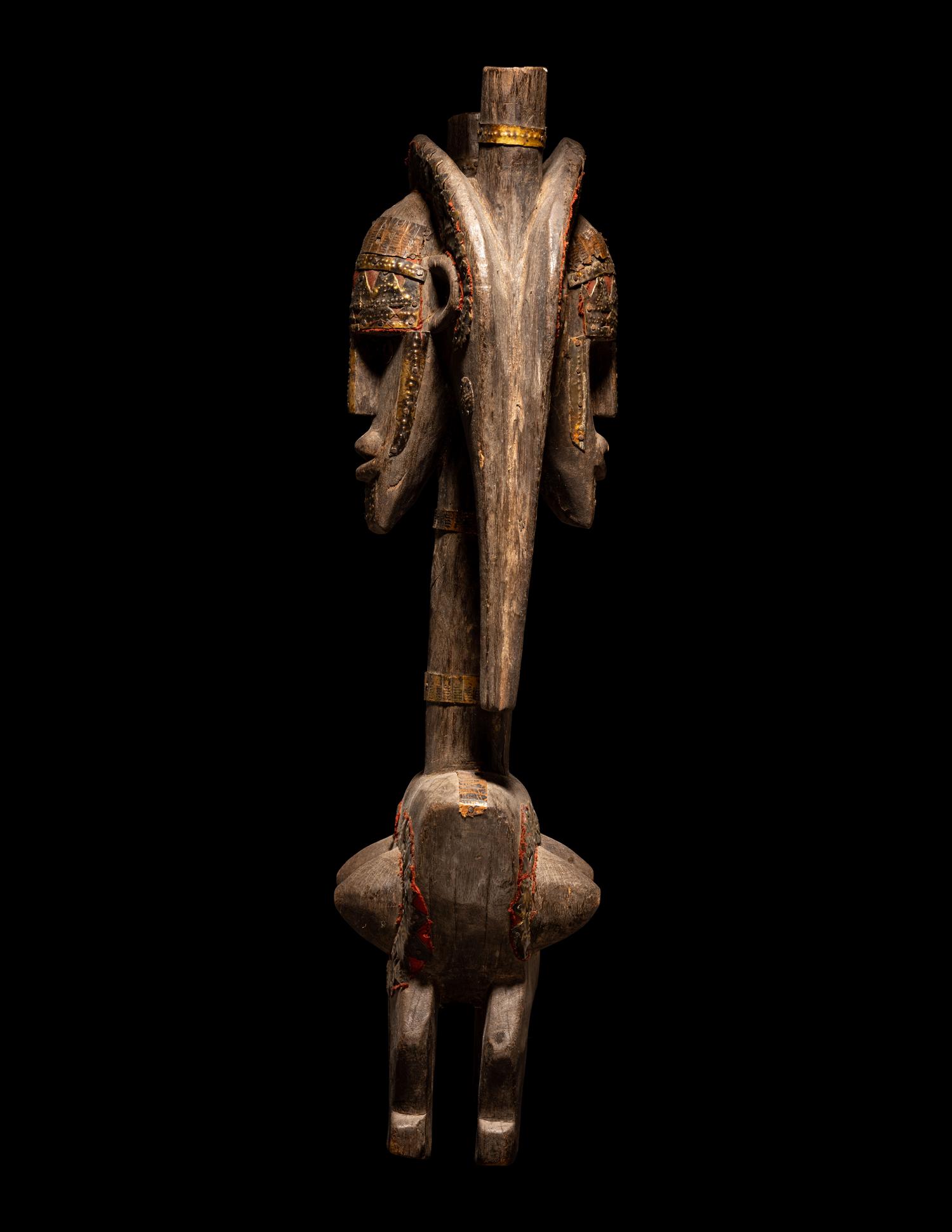 A Bamana Wood Marionette Figure with Eight Wood Puppet Heads