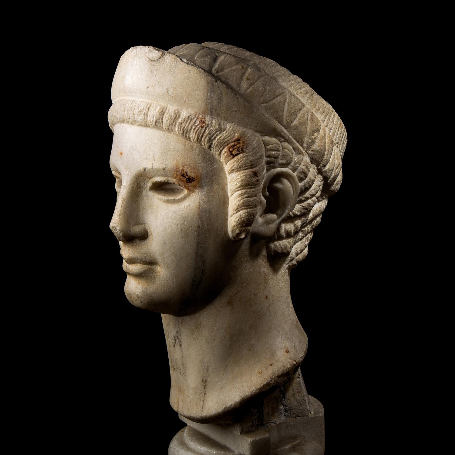 A Roman Marble Archaistic Head of a Goddess