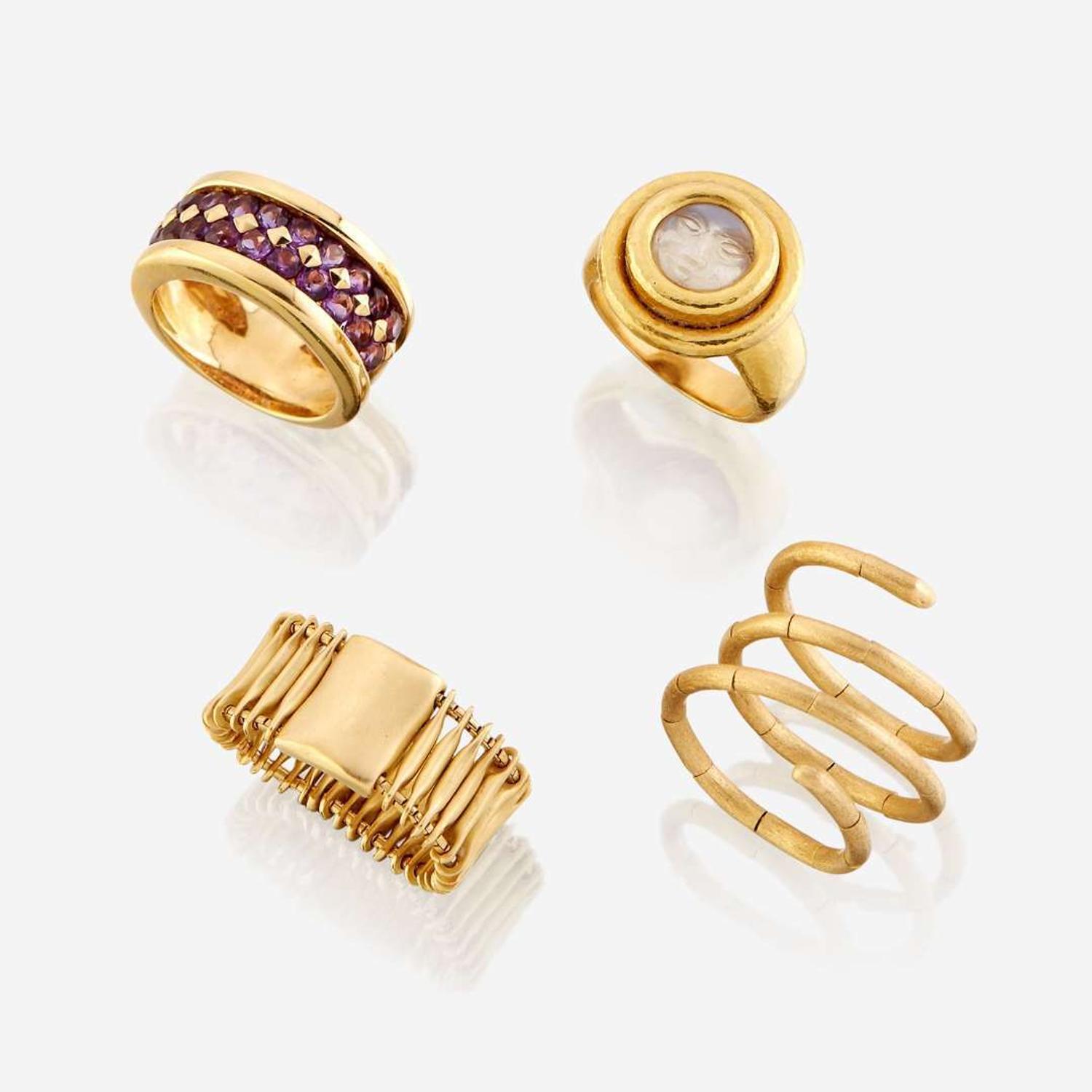 A collection of four eighteen karat gold rings