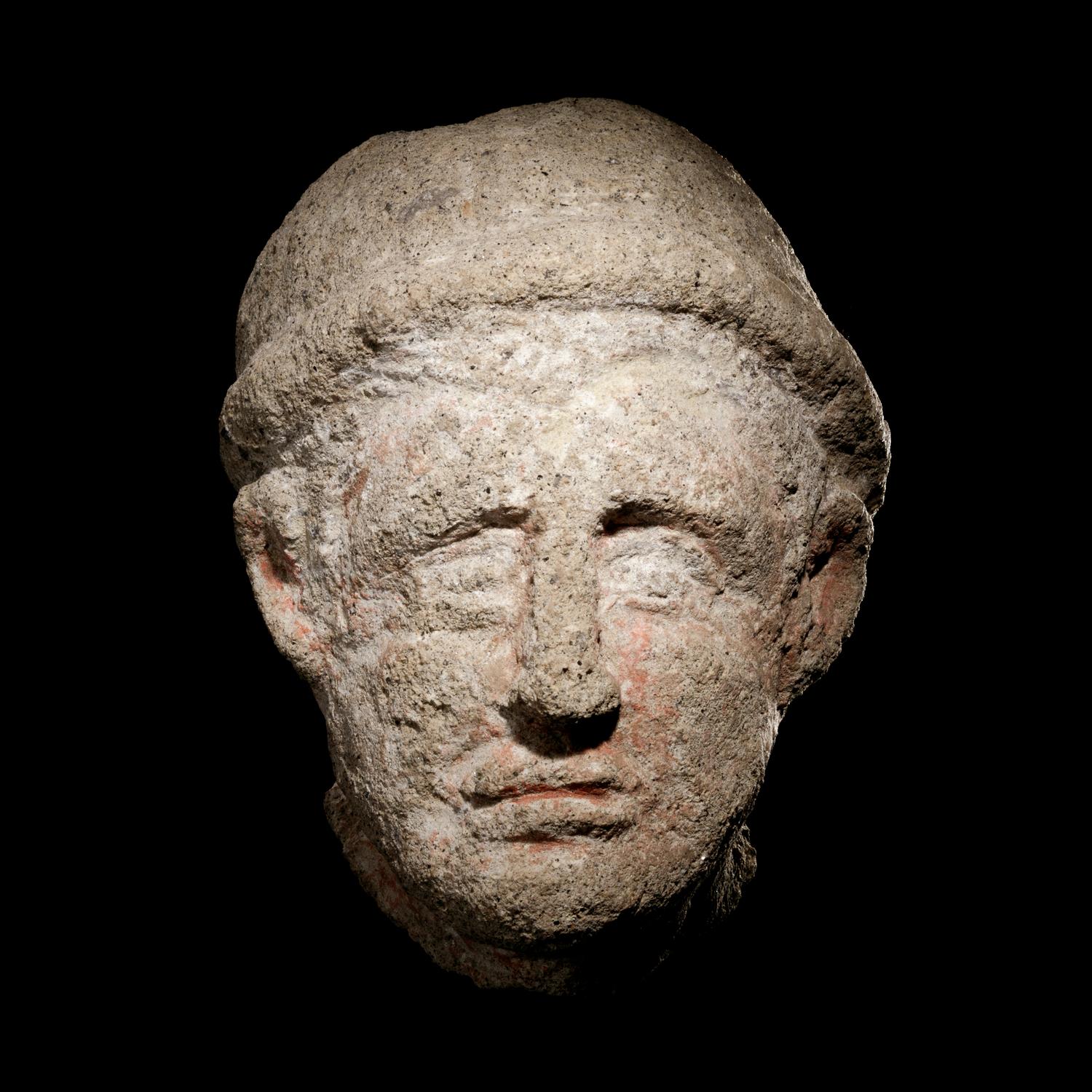 An Etruscan Over-Lifesized Nenfro Portrait Head of a Man