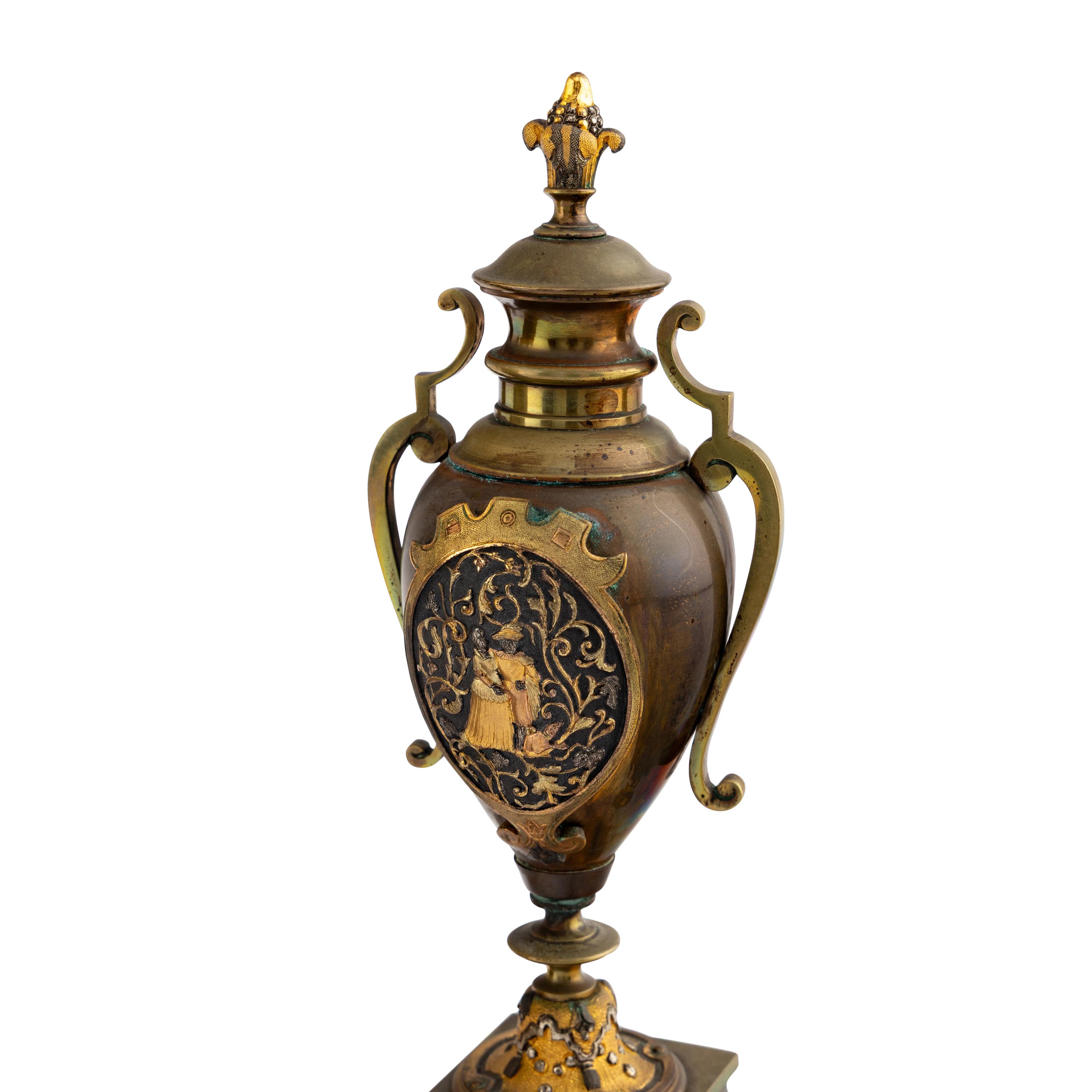 A French Brass and Mixed Metals Clock Garniture