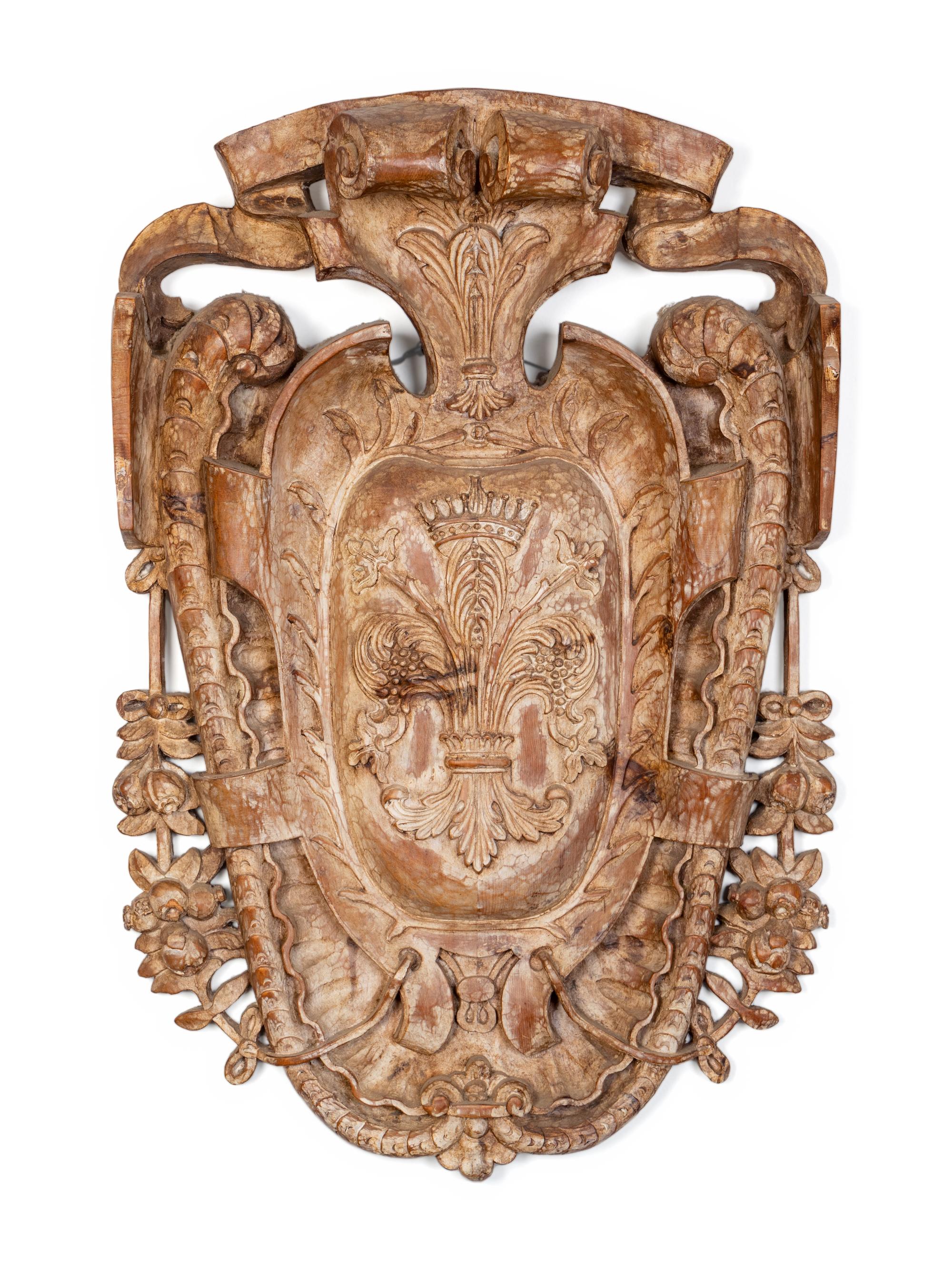 A Baroque Style Carved Wood Cartouche-Form Armorial Plaque