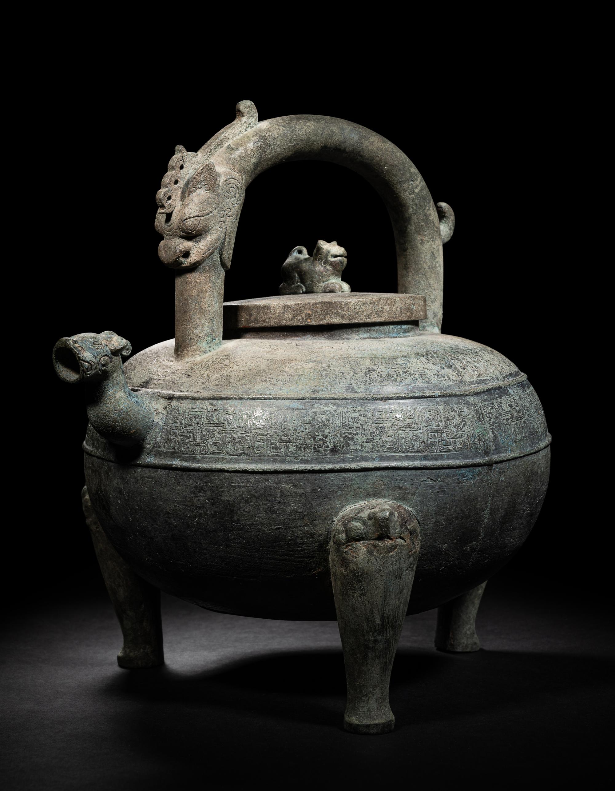 An Archaic Bronze Tripod Wine Vessel, He