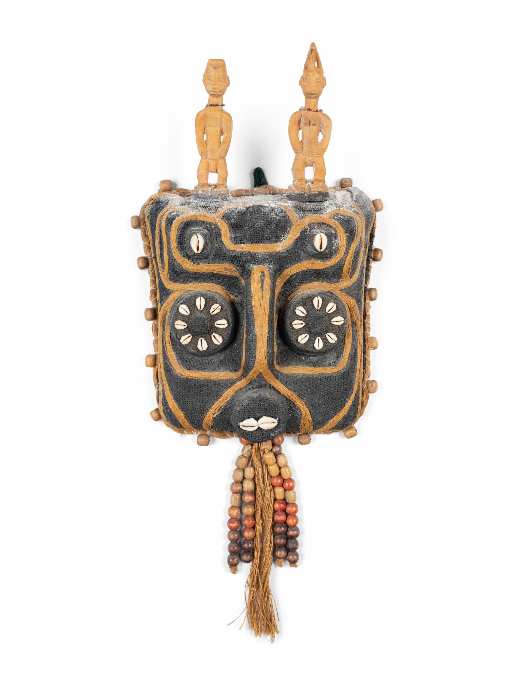 A Benin Shell and Woven Reed Mask with Carved Figures