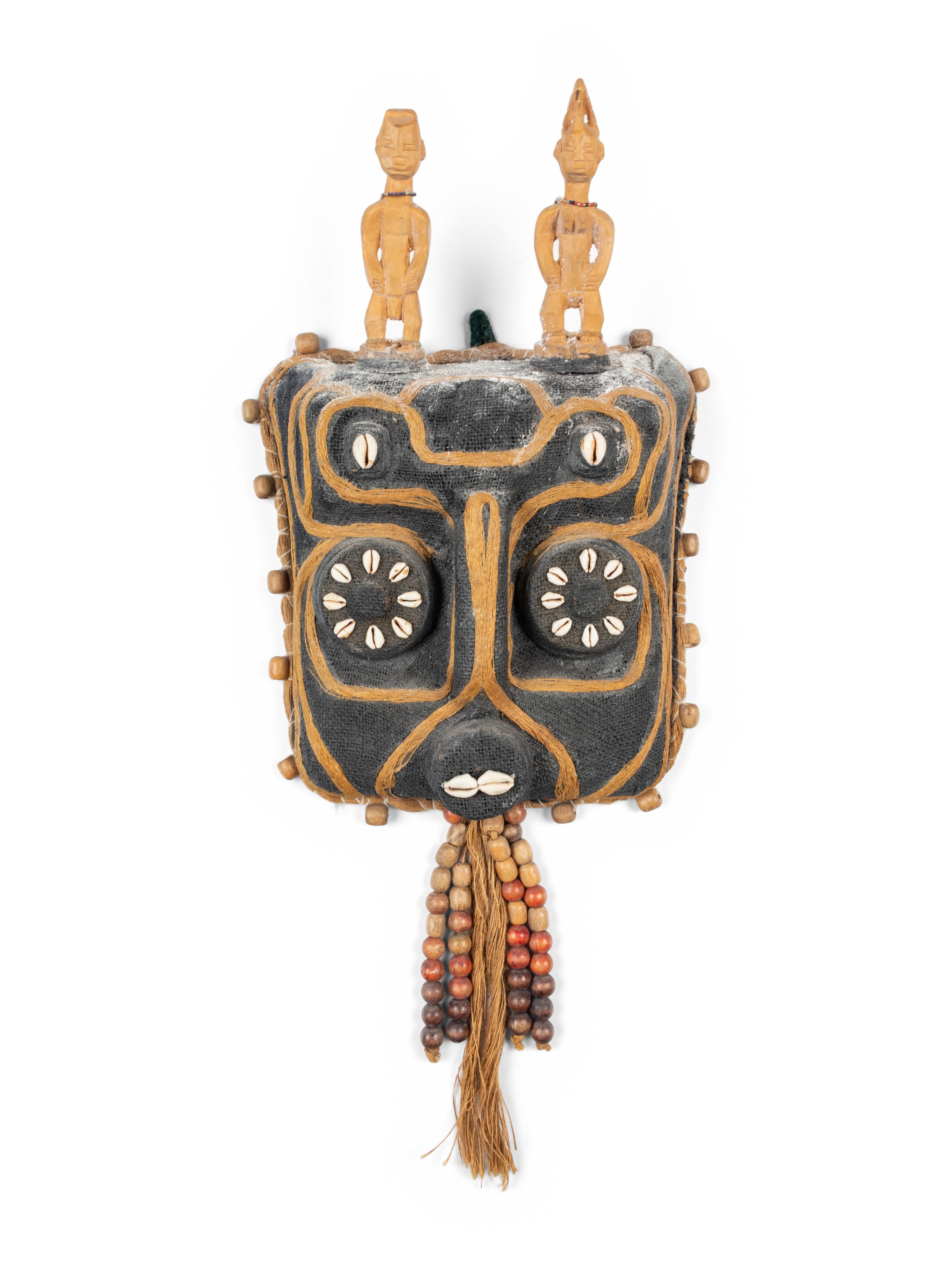 A Benin Shell and Woven Reed Mask with Carved Figures