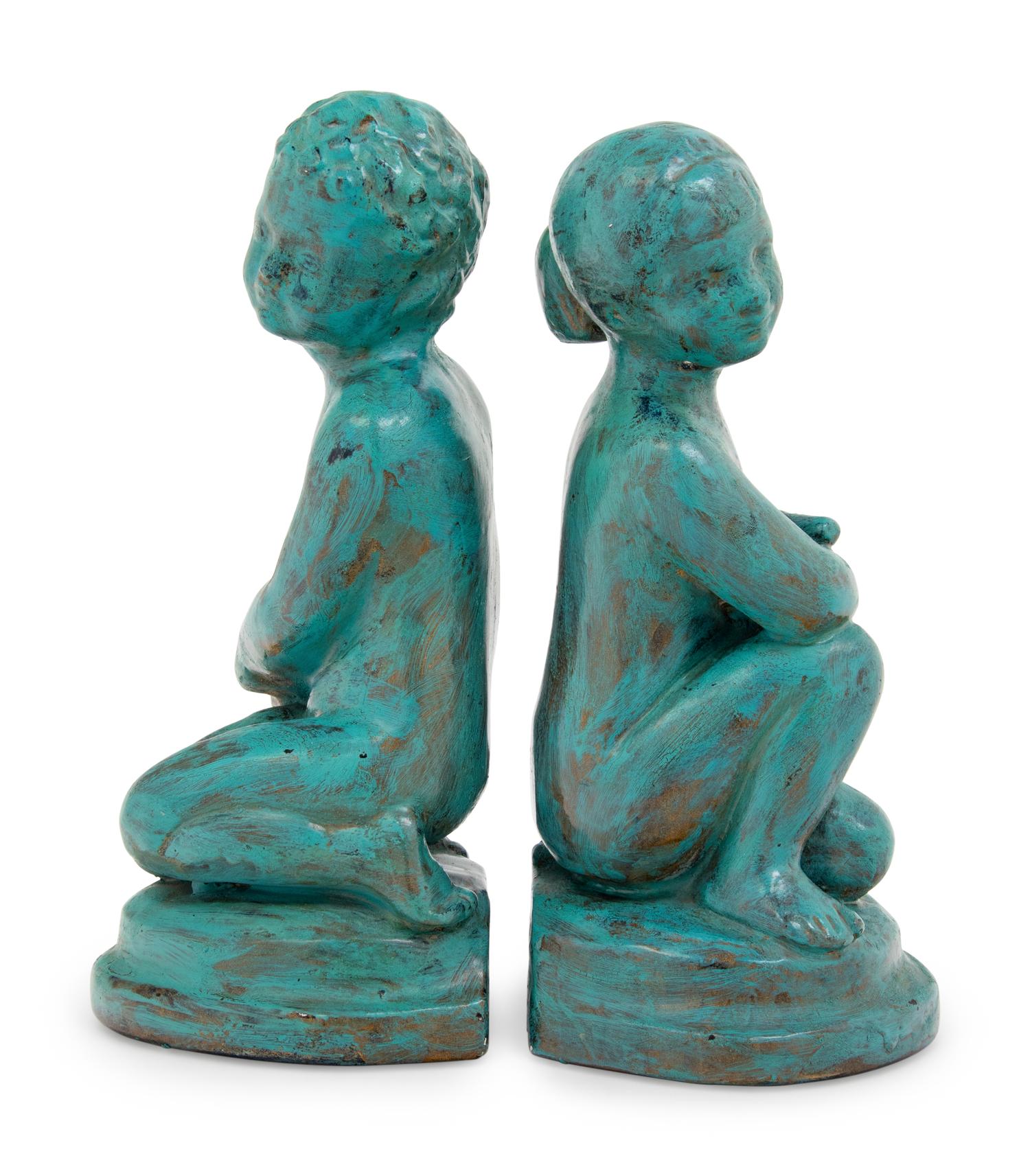 A Pair of Patinated Cast Metal Figures