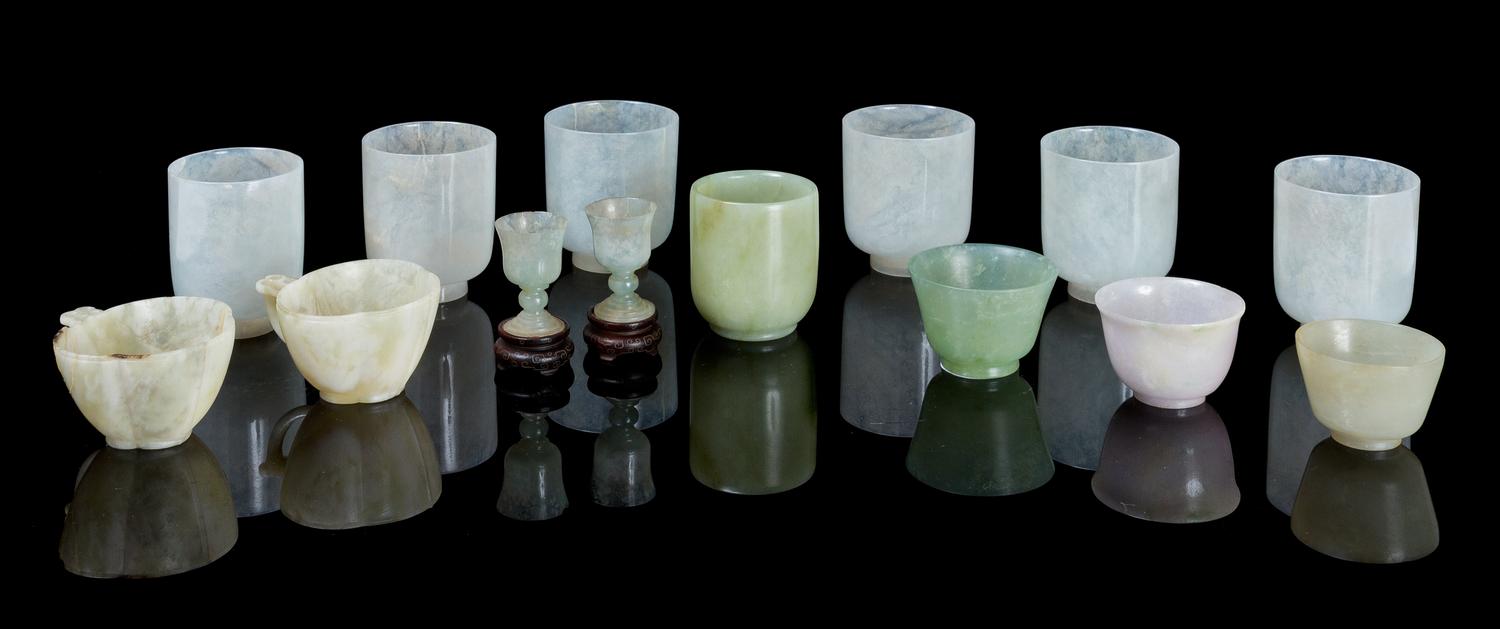 A Collection of Fourteen Jade and Jadeite Cups Height of tallest 2 3/8 inches.