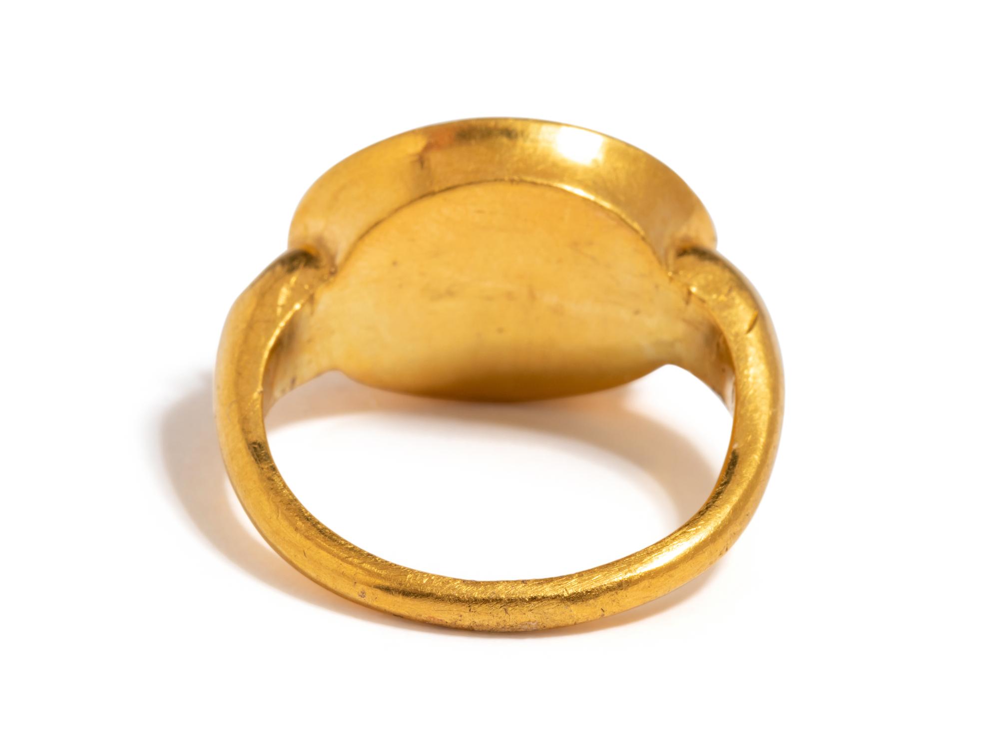 A Roman Carnelian Ring Stone with the God Silenus Surprising a Sleeping Woman — Set in a gold ring