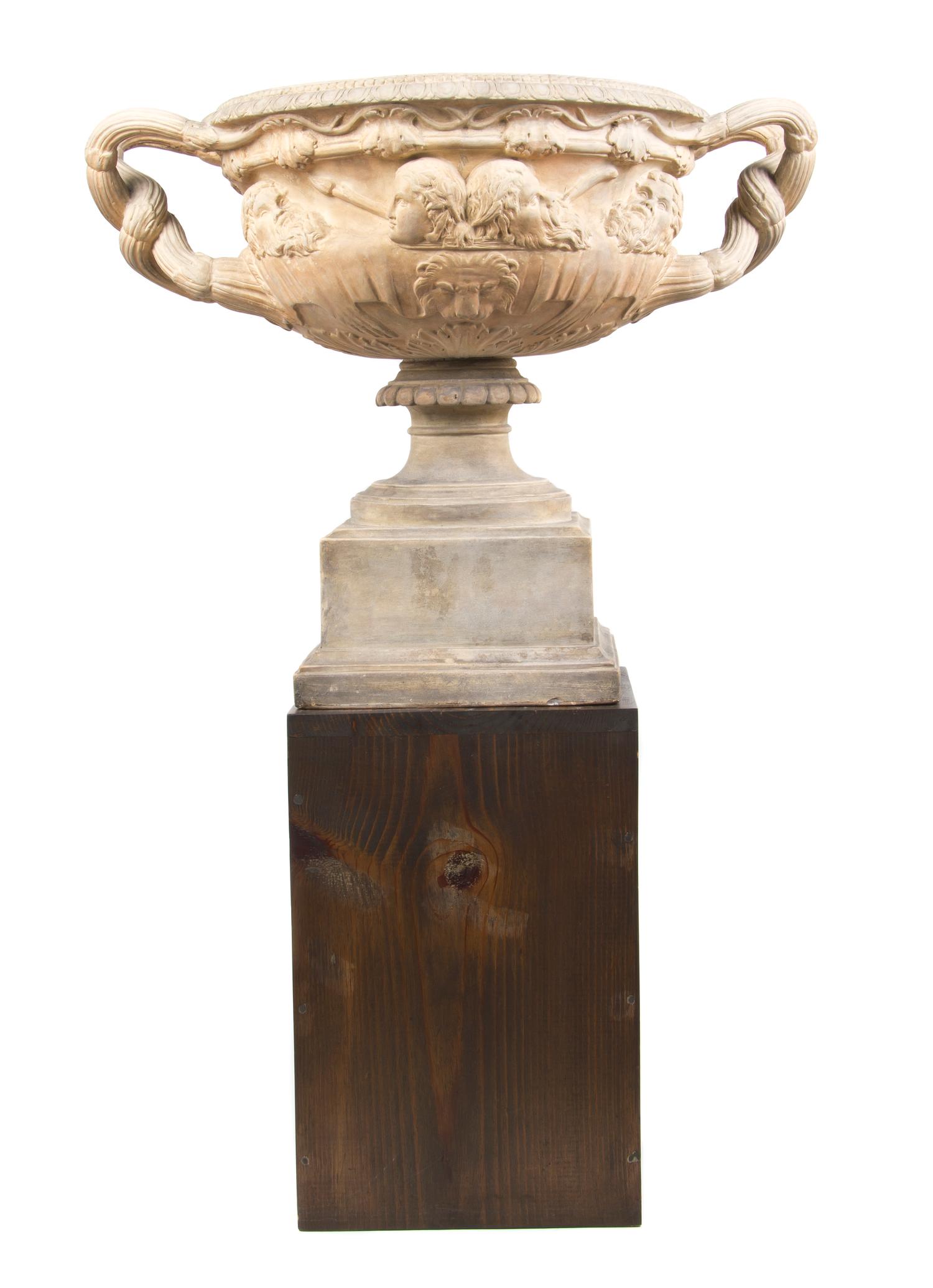 A Neoclassical Style Terracotta Urn, after the Warwick Vase, Width over handles 24 1/2 inches.