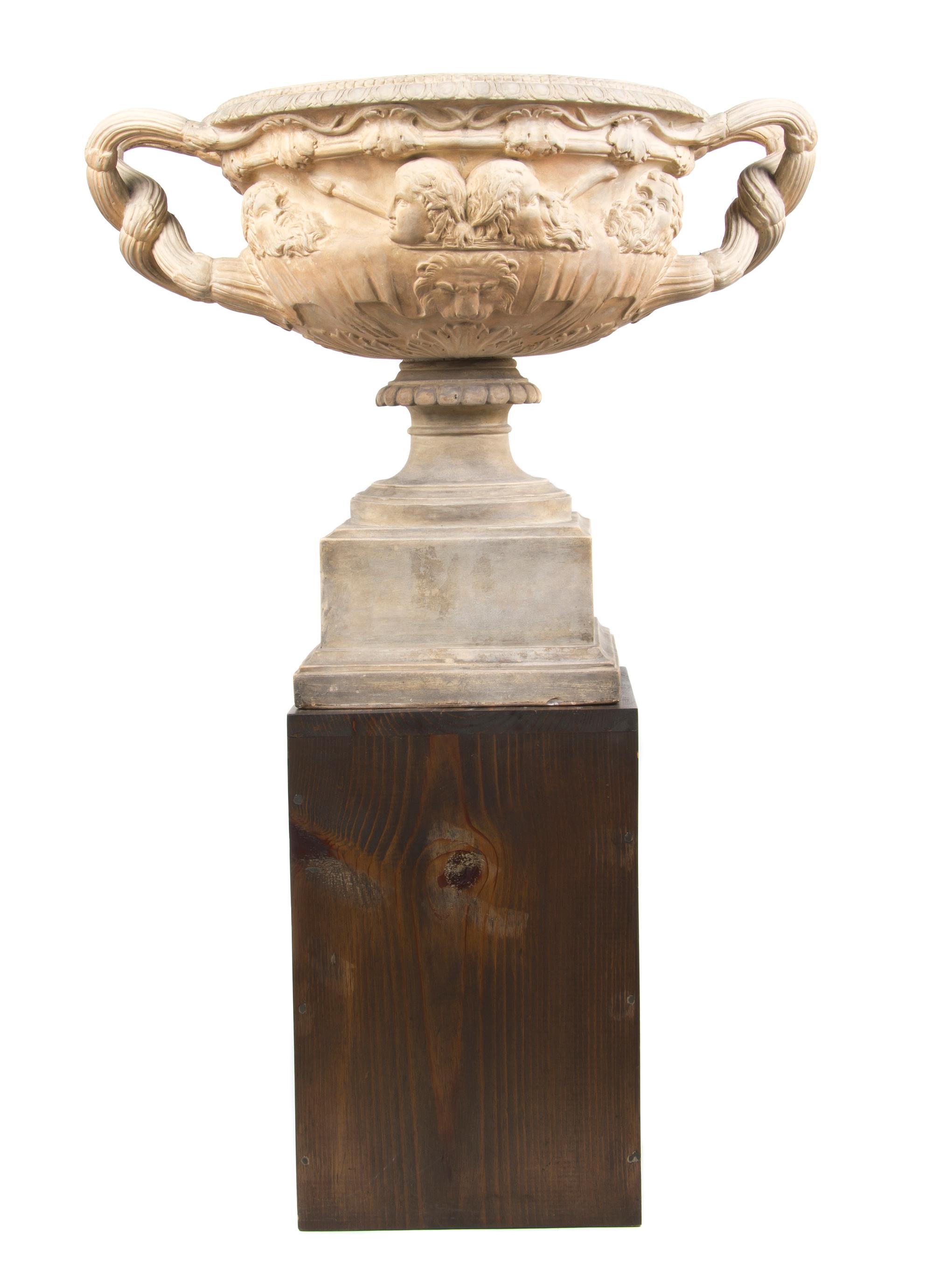 A Neoclassical Style Terracotta Urn, after the Warwick Vase, Width over handles 24 1/2 inches.