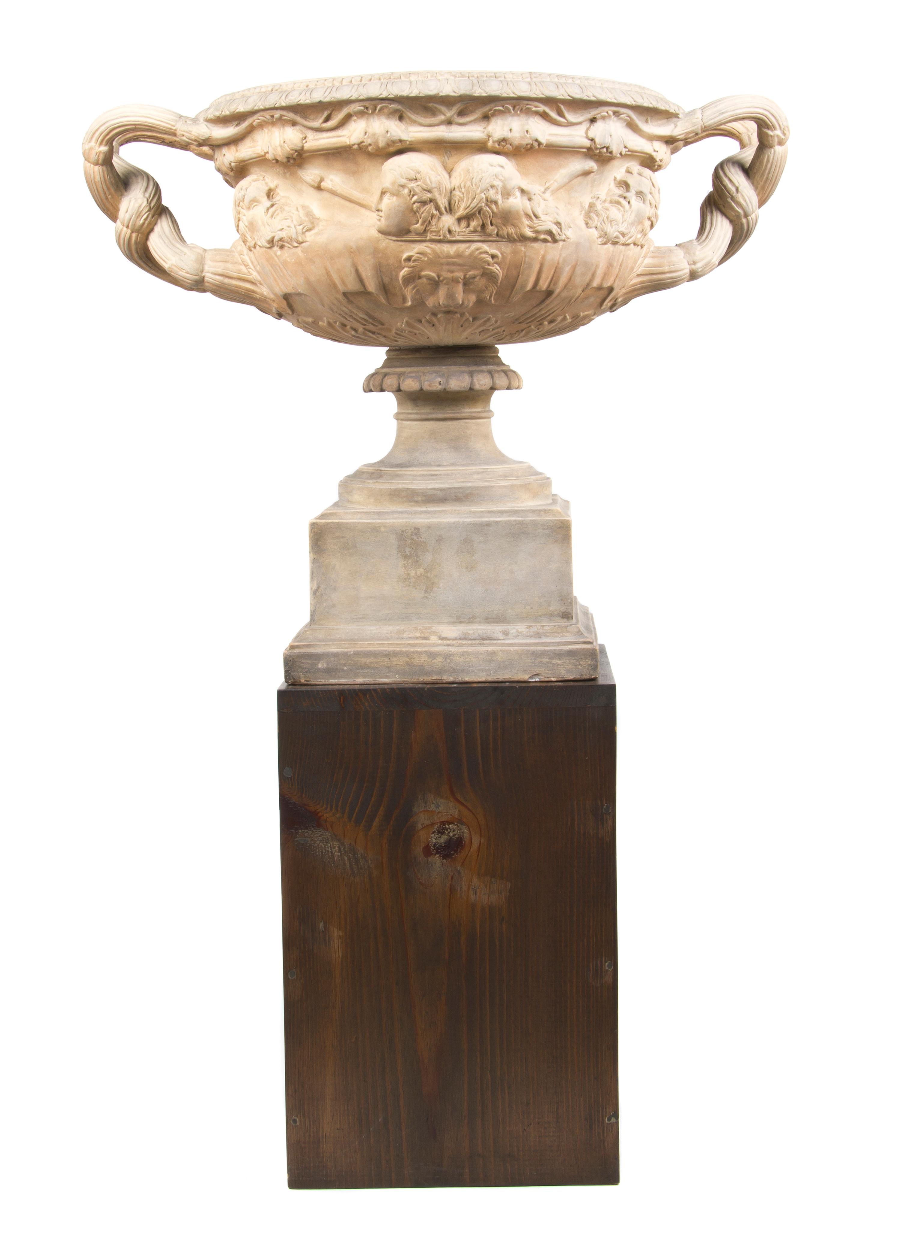 A Neoclassical Style Terracotta Urn, after the Warwick Vase, Width over handles 24 1/2 inches.