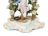 A Pair of Meissen Porcelain Figural Candlesticks with Floral Arbors