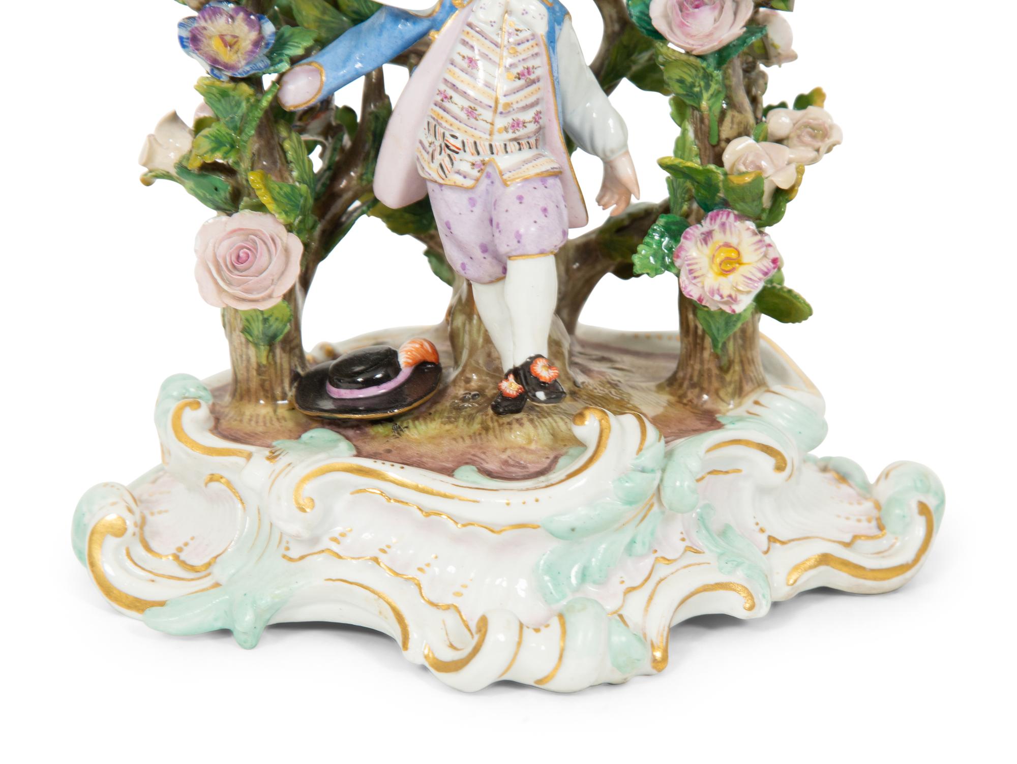 A Pair of Meissen Porcelain Figural Candlesticks with Floral Arbors