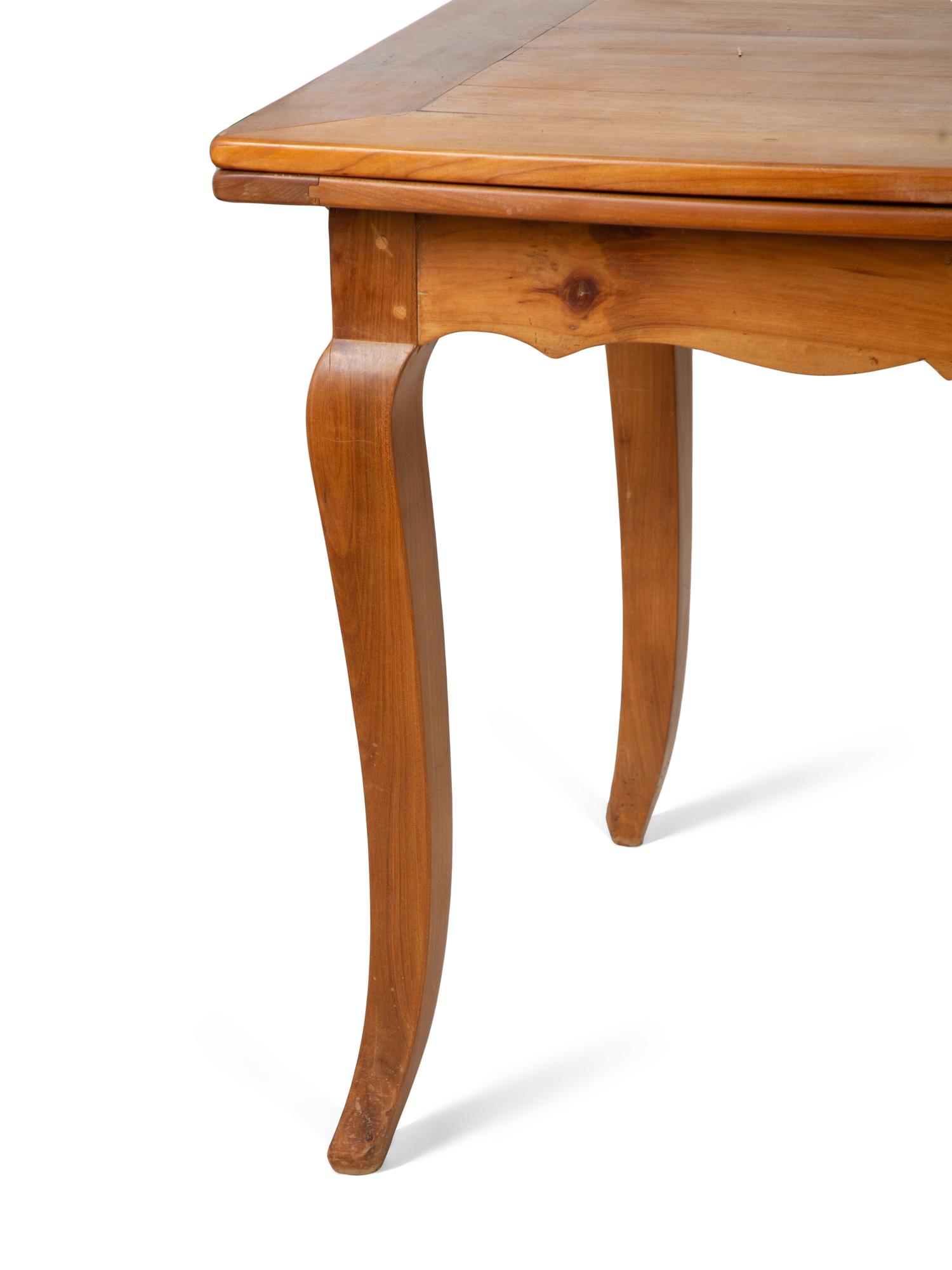 A French Provincial Style Fruitwood Dining Table and Six Side Chairs — 20TH CENTURY