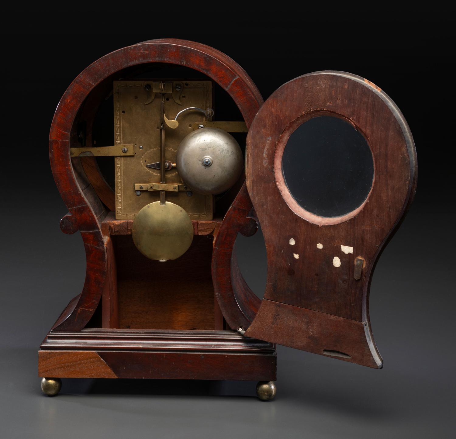 A Federal Carved and Figured Mahogany Balloon-Form Bracket Clock