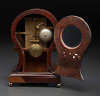 A Federal Carved and Figured Mahogany Balloon-Form Bracket Clock