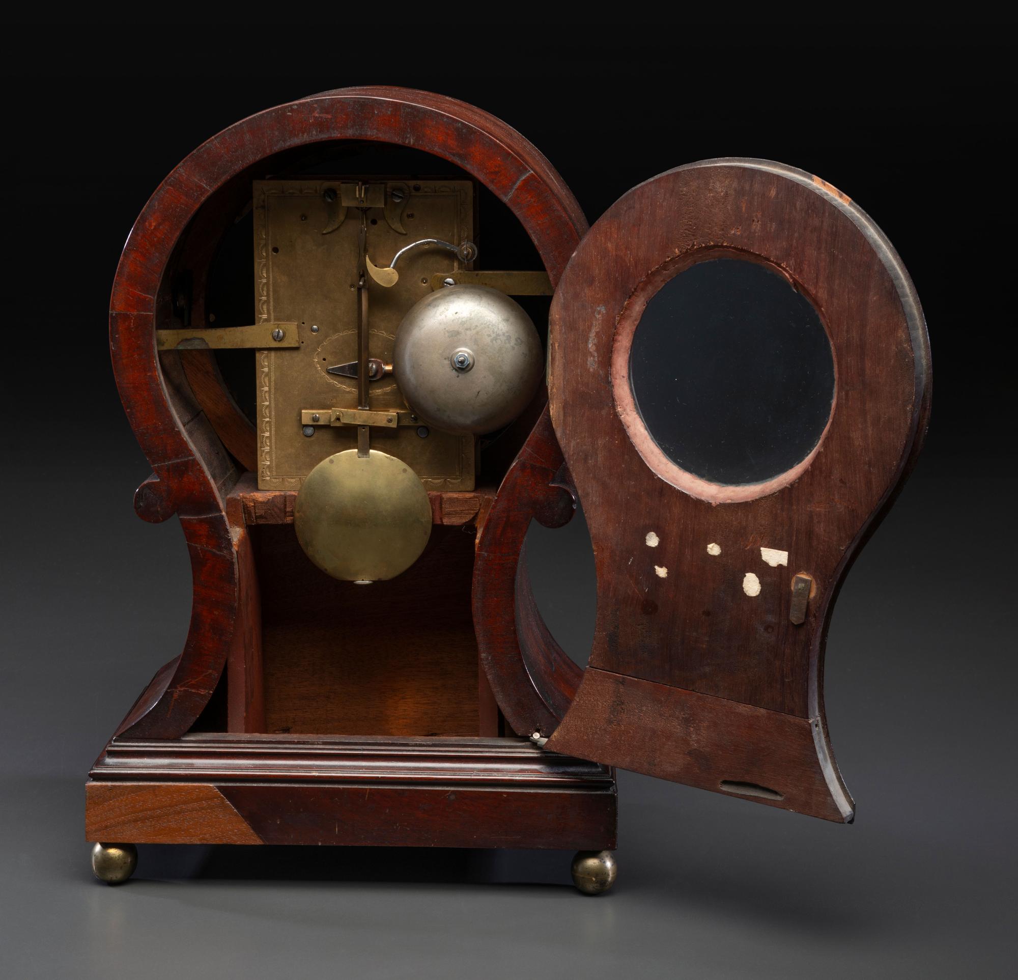 A Federal Carved and Figured Mahogany Balloon-Form Bracket Clock