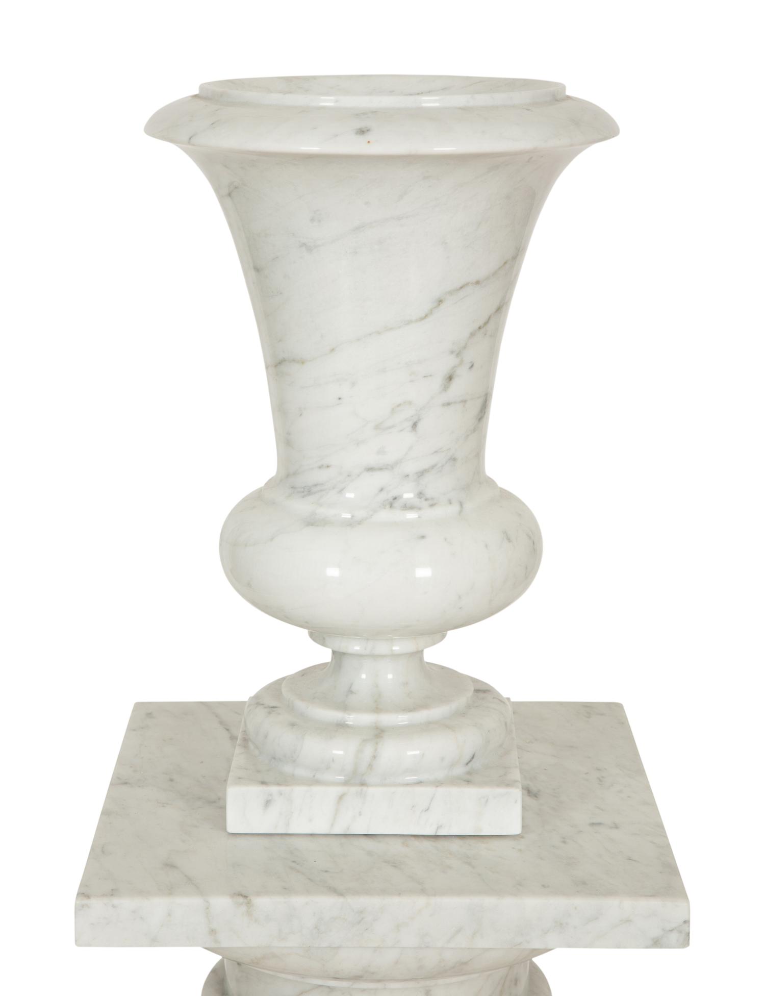 A Pair of White Marble Urns on Matching Pedestals
