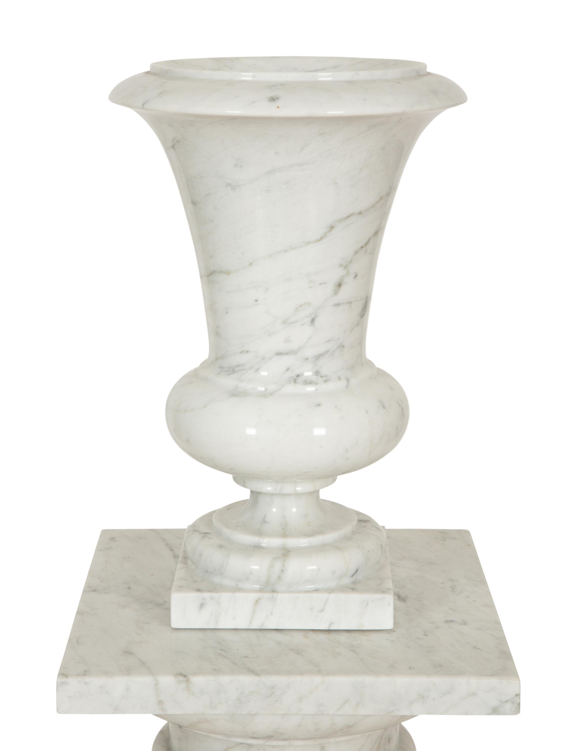 A Pair of White Marble Urns on Matching Pedestals