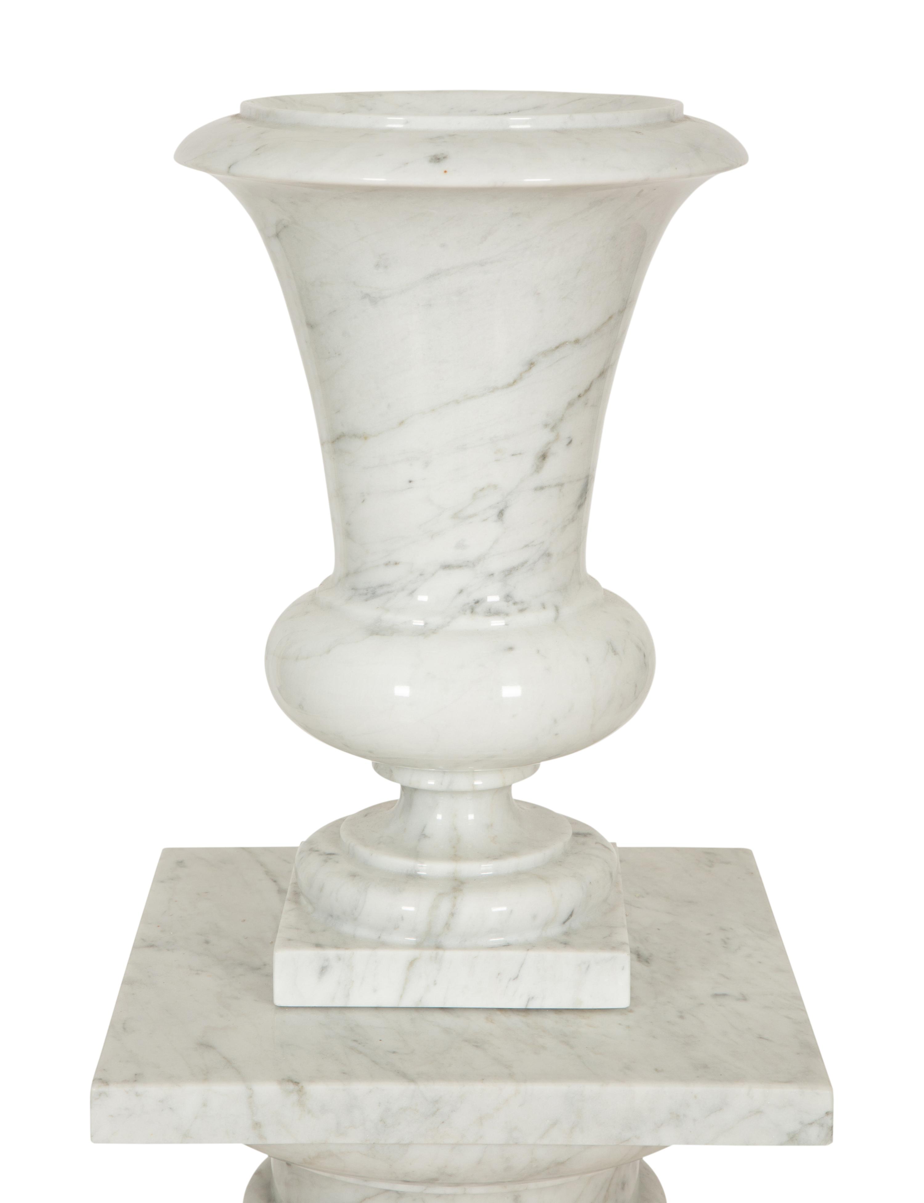 A Pair of White Marble Urns on Matching Pedestals