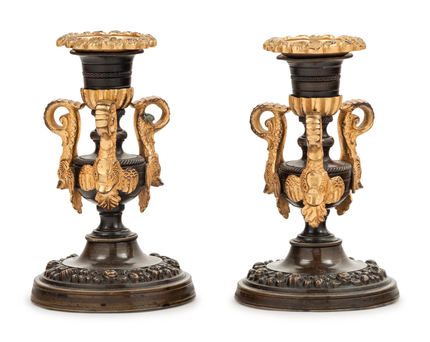 A Pair of Patinated and Gilt Bronze Candlesticks