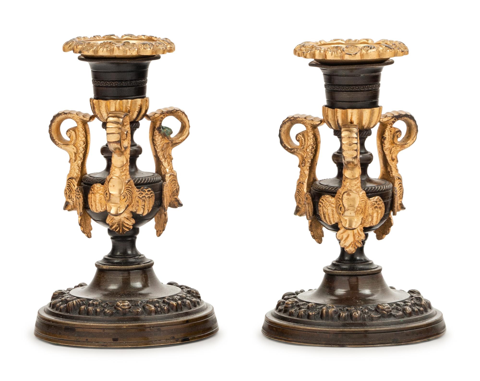 A Pair of Patinated and Gilt Bronze Candlesticks