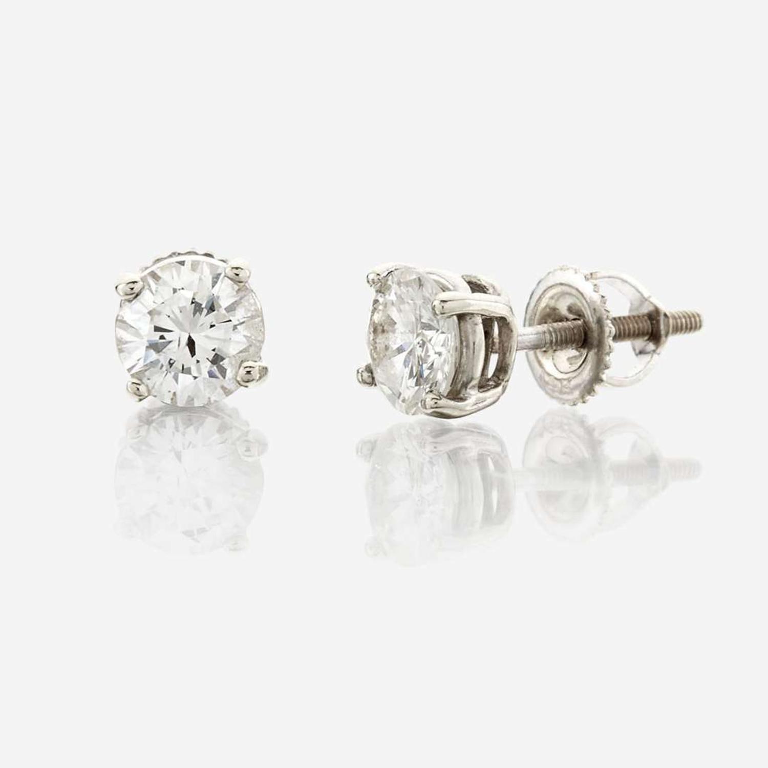 A pair of diamond and white metal earrings