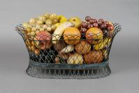 A Collection of Painted Stone Fruit, Height of basket 8 1/4 x width 18 inches.