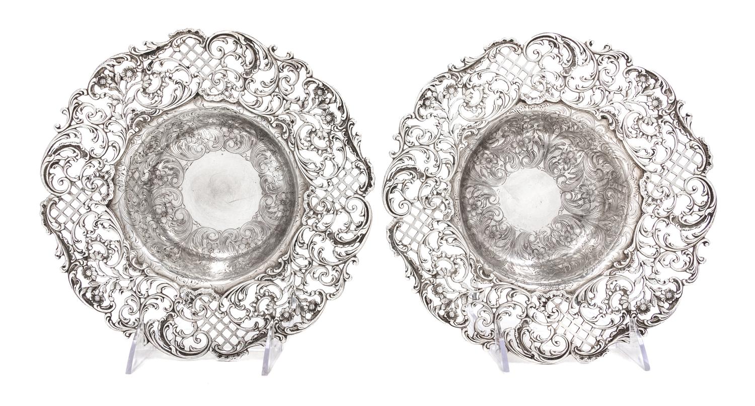 A Pair of American Silver Center Bowls, J.E. Caldwell & Co., Philadelphia, PA, the rims with pierced floral, foliate and lattice decora