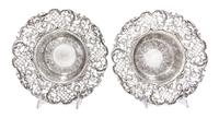 A Pair of American Silver Center Bowls, J.E. Caldwell & Co., Philadelphia, PA, the rims with pierced floral, foliate and lattice decora