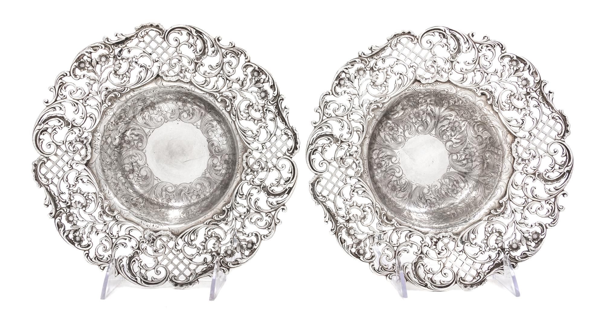 A Pair of American Silver Center Bowls, J.E. Caldwell & Co., Philadelphia, PA, the rims with pierced floral, foliate and lattice decora