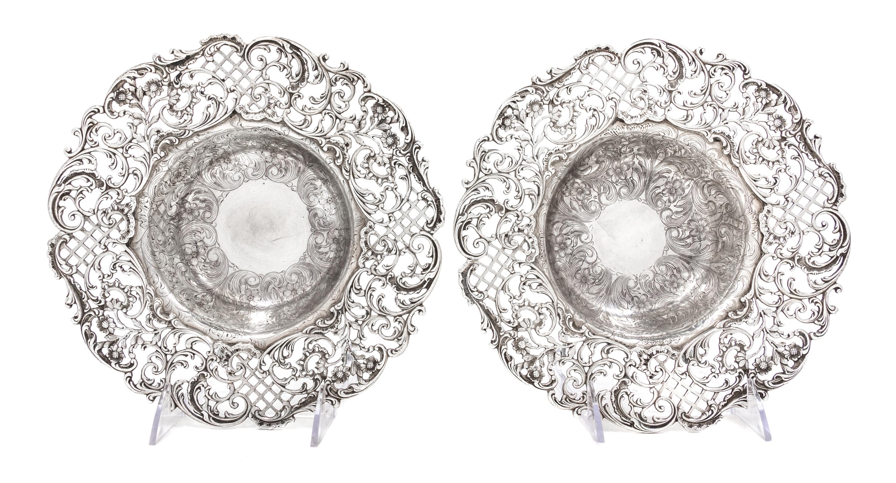 A Pair of American Silver Center Bowls, J.E. Caldwell & Co., Philadelphia, PA, the rims with pierced floral, foliate and lattice decora