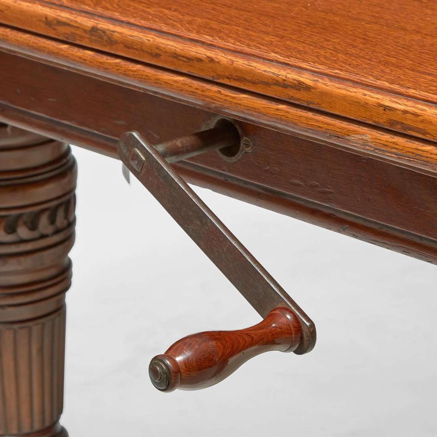An English Aesthetic Movement carved oak dining table and set of twelve dining chairs Lamb of Manchester, Manchester, England, circa 1875