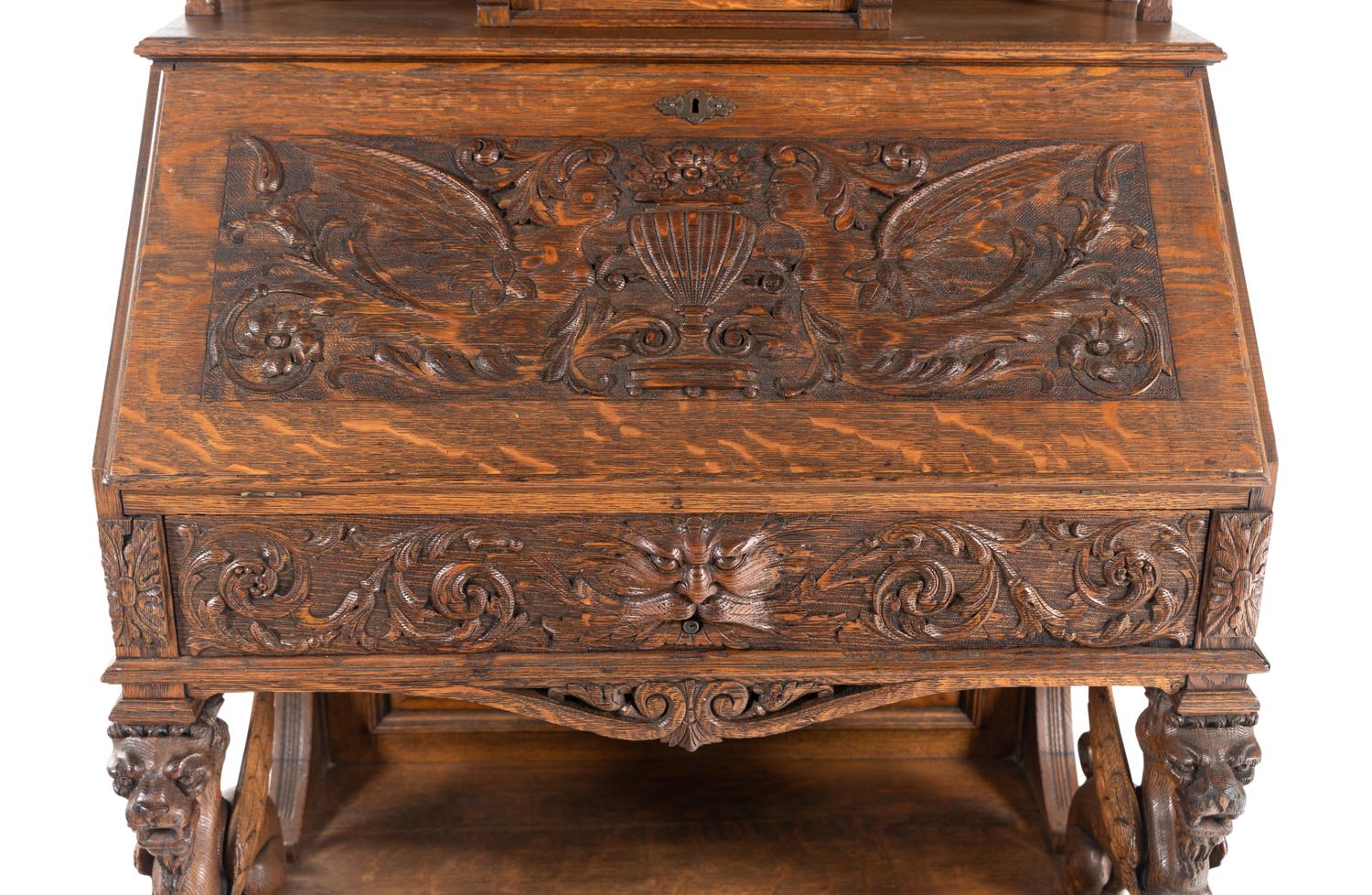 A Renaissance Revival Carved Oak Slant-Front Bureau